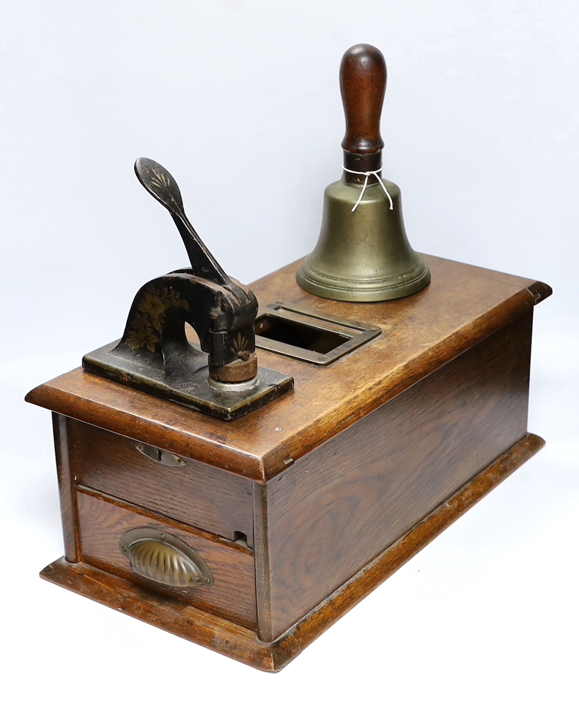 A Victorian oak Till and Company paper stamp from Alex Rice Ltd, formerly Fisher St., Lewes, and a Victorian handbell, largest 46cm wide (3)